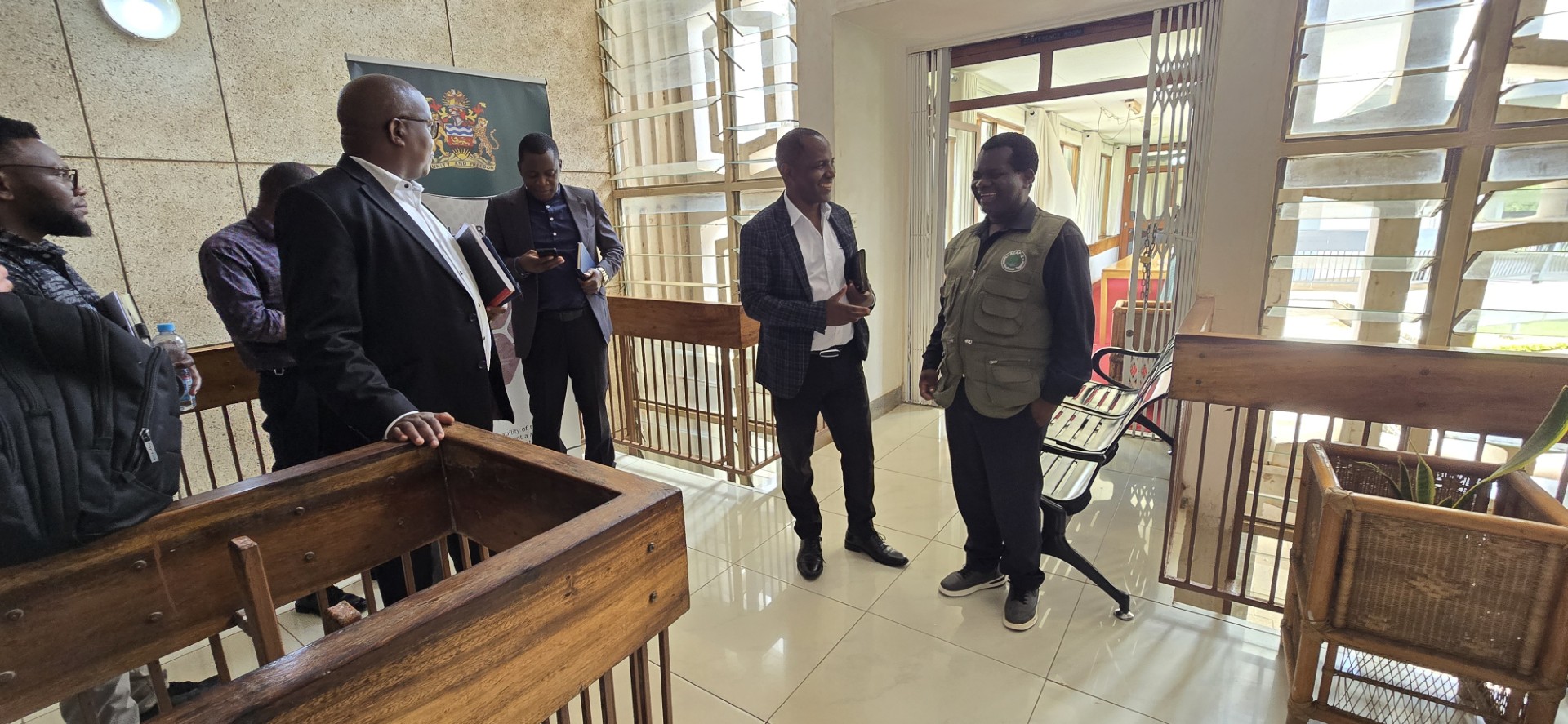 RCRP-2-Project-Coordinator-Adwell-Zembele-having-a-moment-with-Roads-Authority-CEO-Eng-Ammiel-Champiti-at-the-end-of-the-World-Bank-Wrap-up-Session-at-Treasury-Large